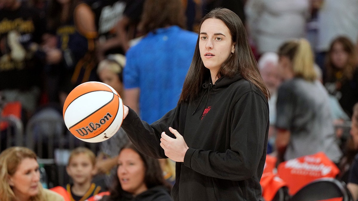 Caitlin Clark dribbles ball